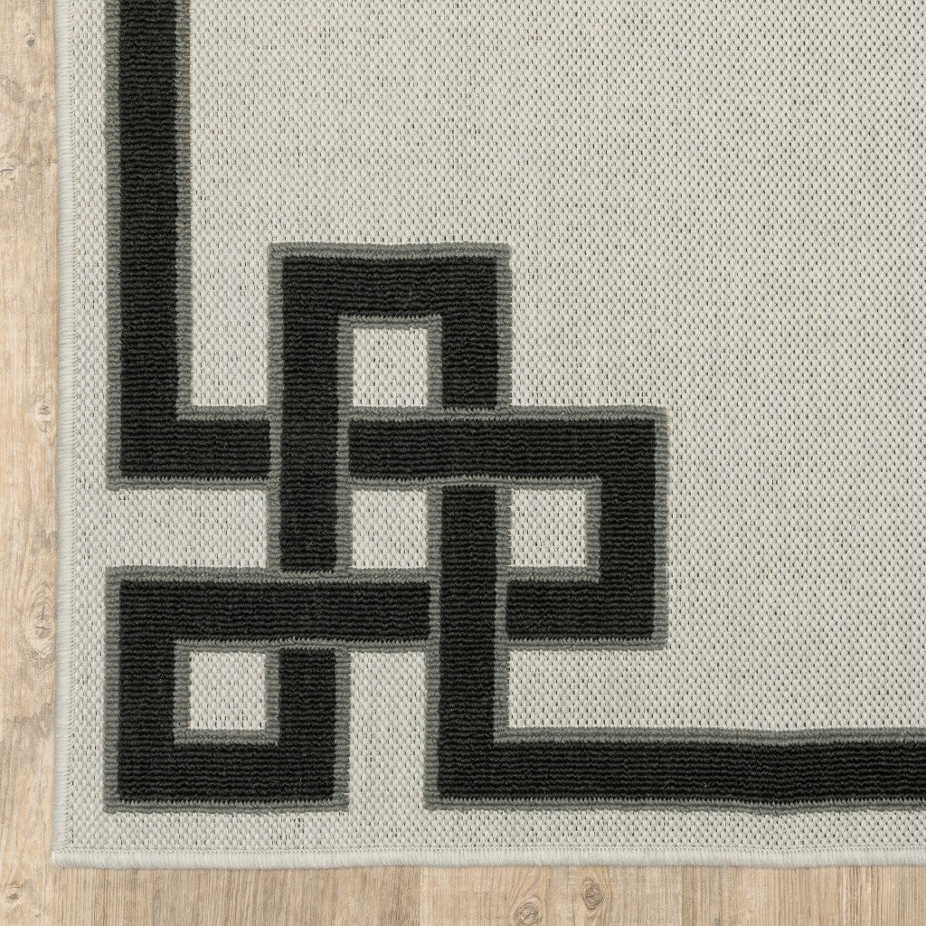 5' x 7' Beige and Black Stain Resistant Indoor Outdoor Area Rug