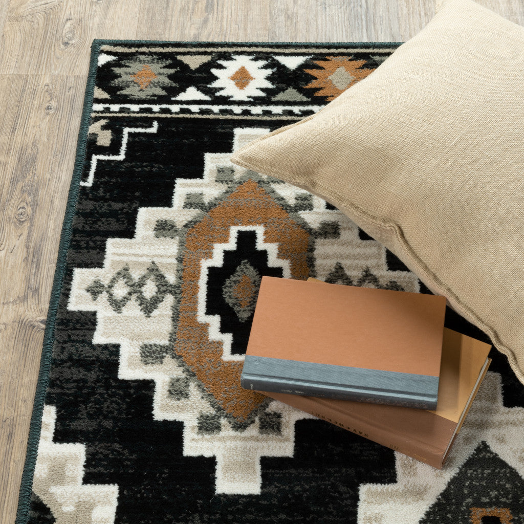 10' X 13' Black Grey Tan Orange And Ivory Southwestern Power Loom Stain Resistant Area Rug