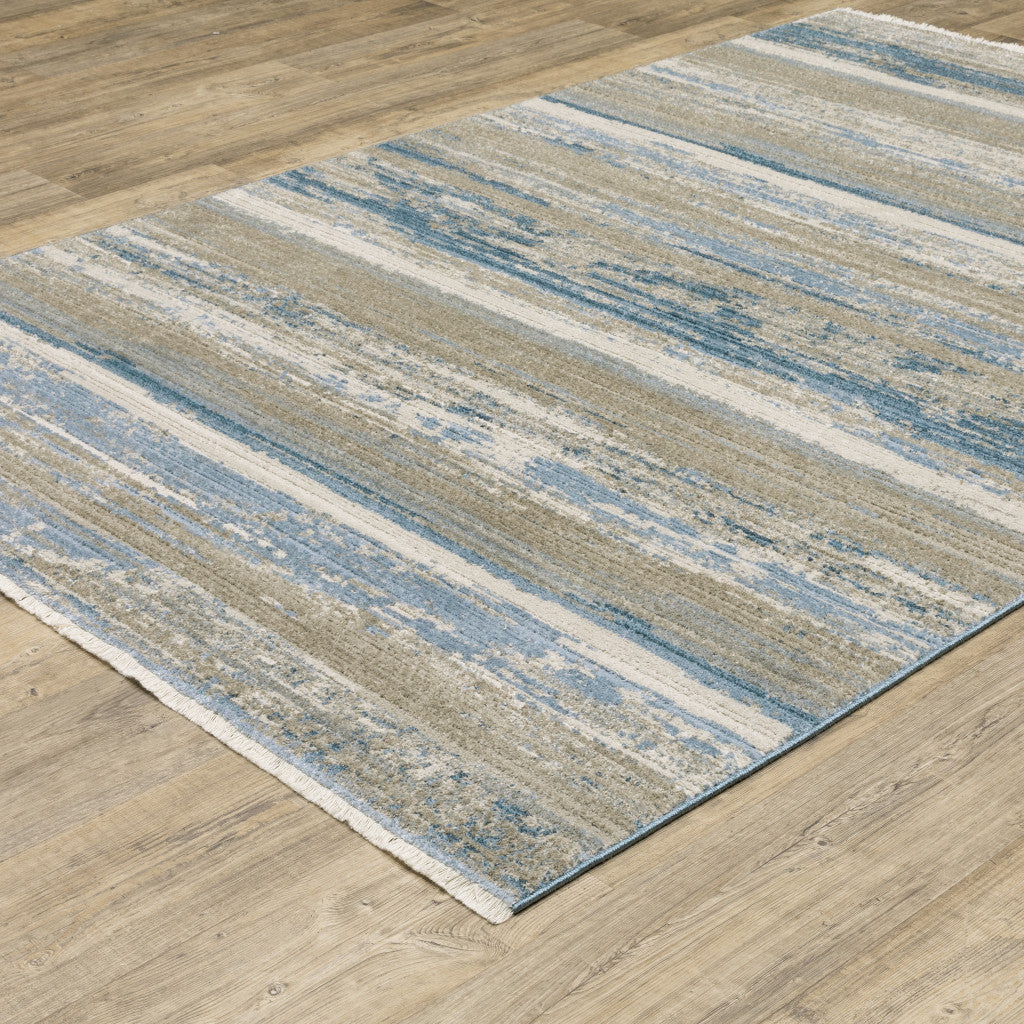 10' X 13' Ivory Beige Grey Blue And Tan Abstract Power Loom Stain Resistant Area Rug With Fringe