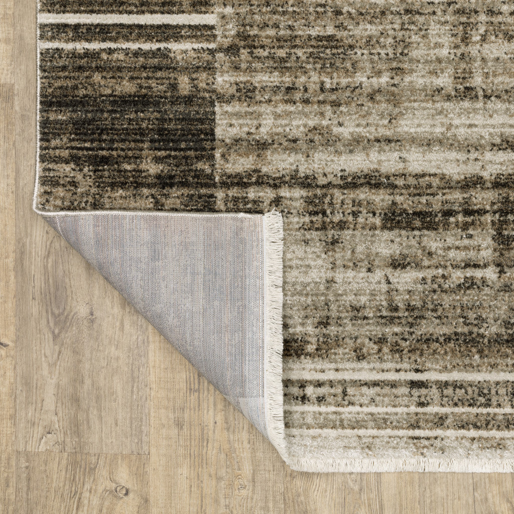 10' X 13' Beige Charcoal Brown Grey Tan Gold And Blue Geometric Power Loom Stain Resistant Area Rug With Fringe