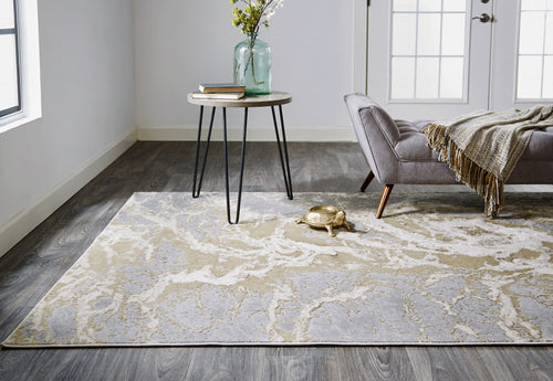 7' X 10' Ivory Silver And Gold Abstract Stain Resistant Area Rug