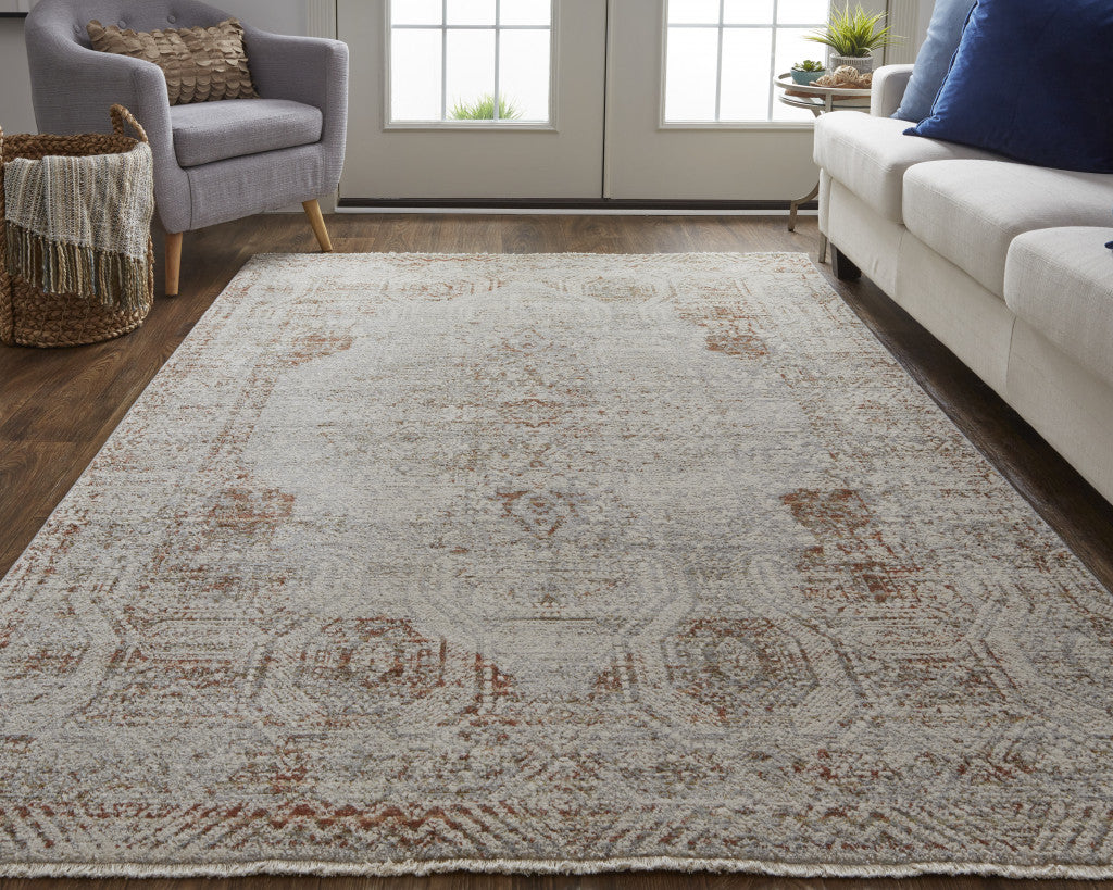 10' X 13' Tan Ivory And Orange Floral Power Loom Distressed Area Rug With Fringe