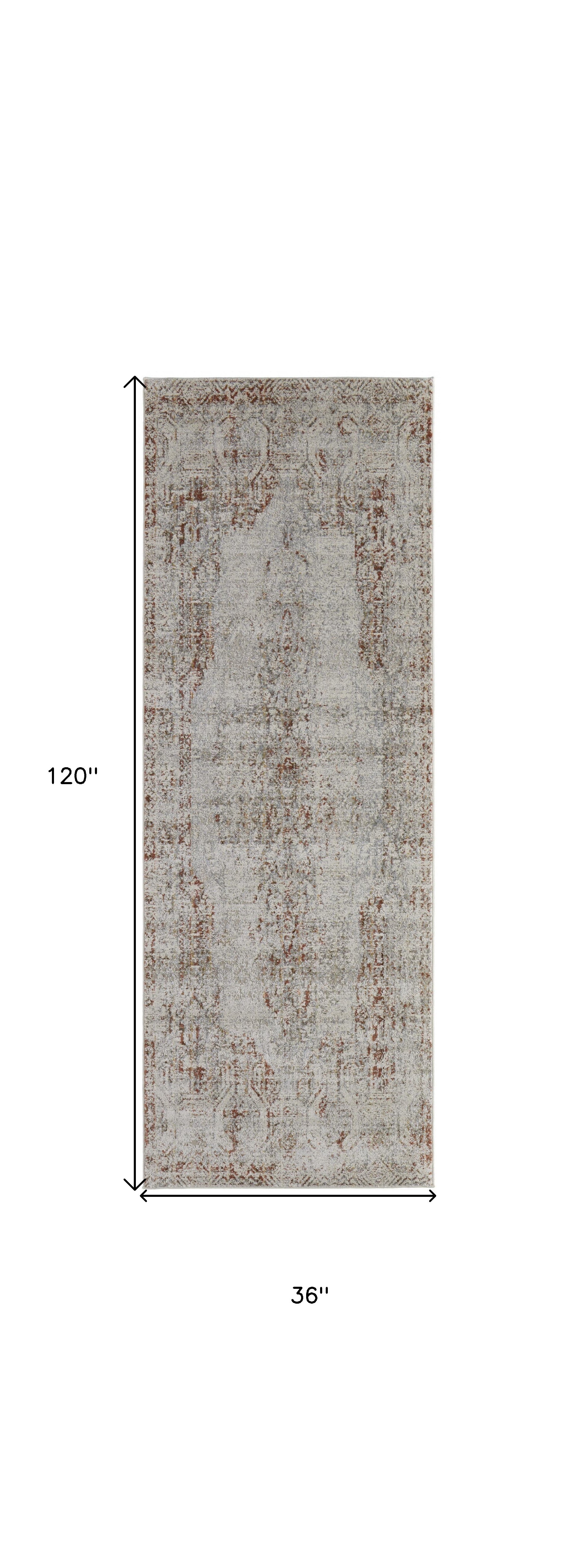 10' Tan Ivory And Orange Floral Power Loom Distressed Runner Rug With Fringe